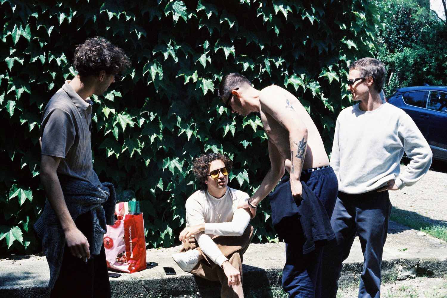 The band gathered outside against an ivy-covered wall